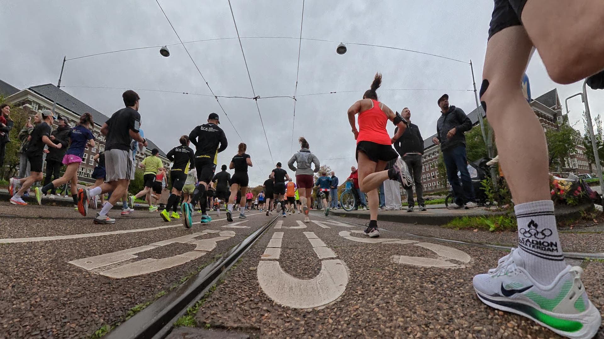 Runners on a city street at the start of a road race